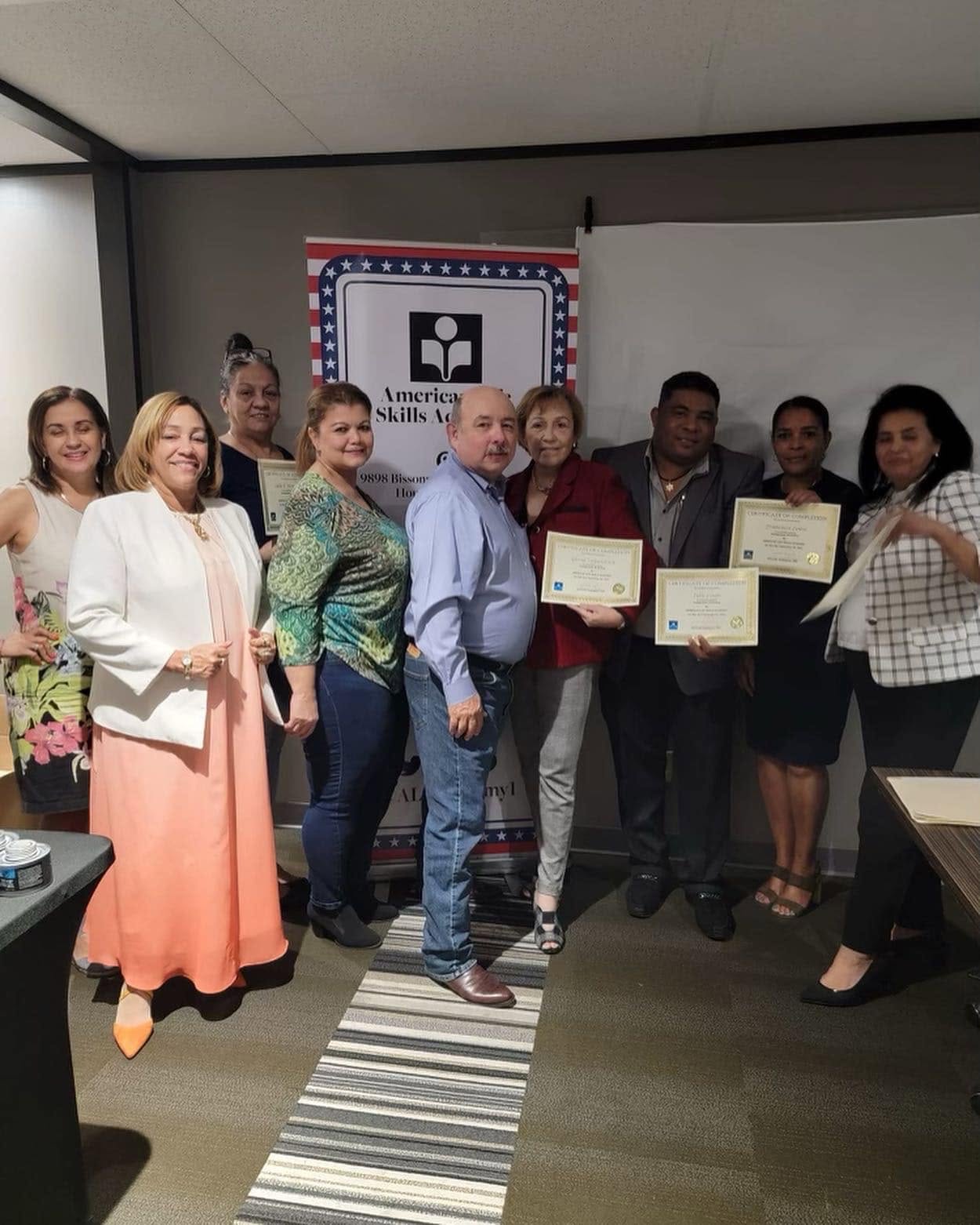 Workshop participants holding their certificates of completion